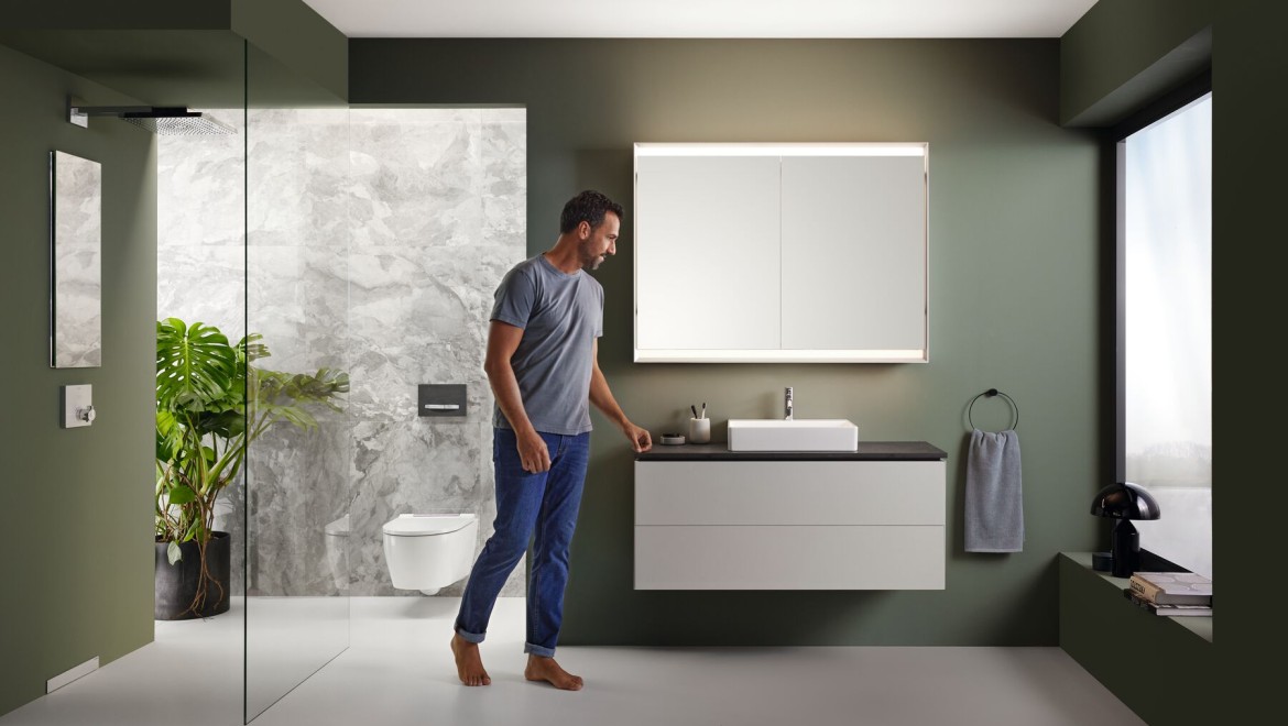 Modern open-plan bathroom with freestanding tub and wall-hung toilet, showcasing concealed structural supports.